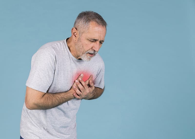 senior man having chest pains