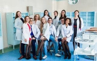 Education and health. general practitioner. A group of smart medical students in college. Friends interns in the surgery room in white coats. Team work at the university.